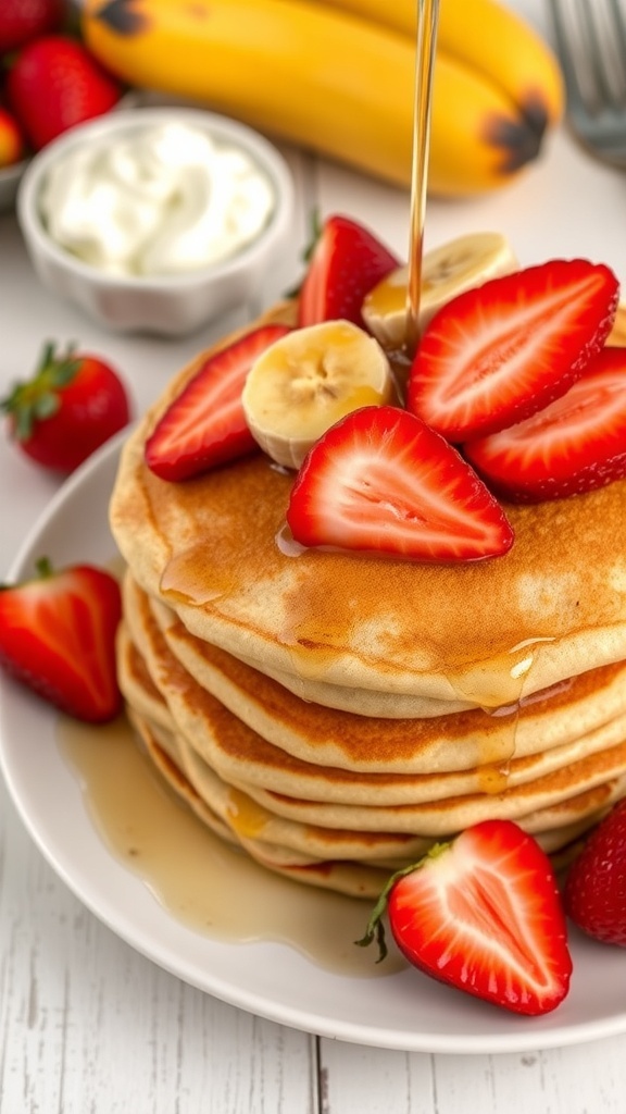 Fluffy strawberry banana pancakes topped with strawberries and maple syrup on a rustic table.